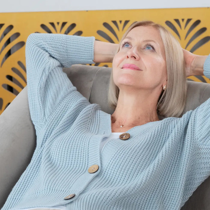 Magnesium glycinate supplement bottle with magnesium rich foods like pumpkin seeds, nuts, and leafy greens on a light background