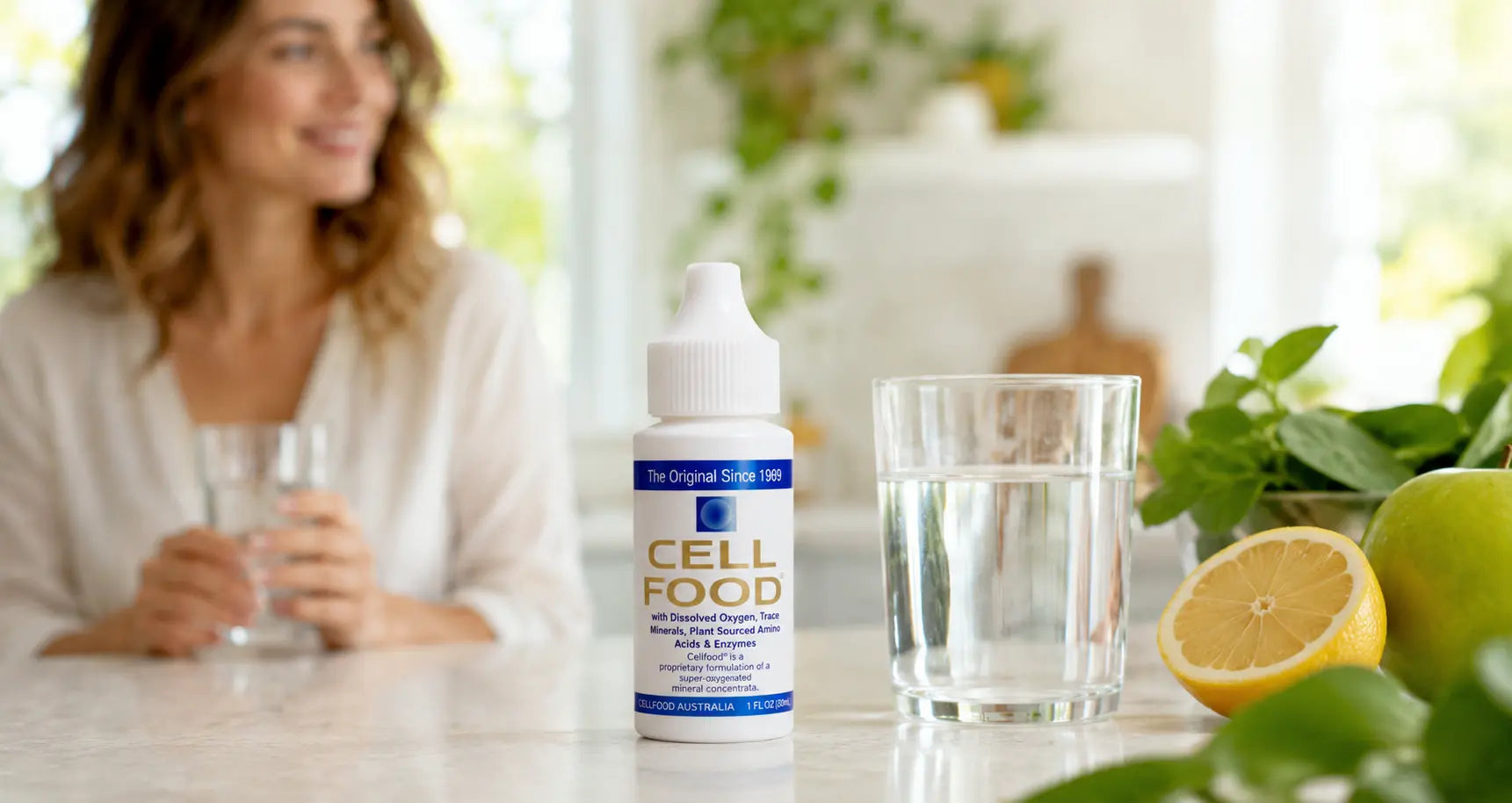 Cell Food drops beside a glass of water for a daily wellness and hydration routine