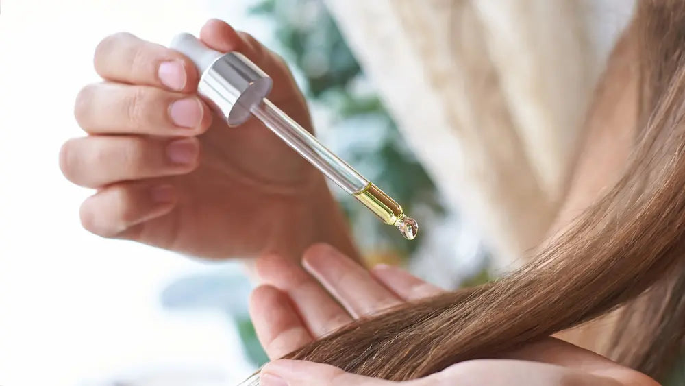 Castor oil beside a lighter carrier oil showing neat use for hair ends and blended use for larger skin areas