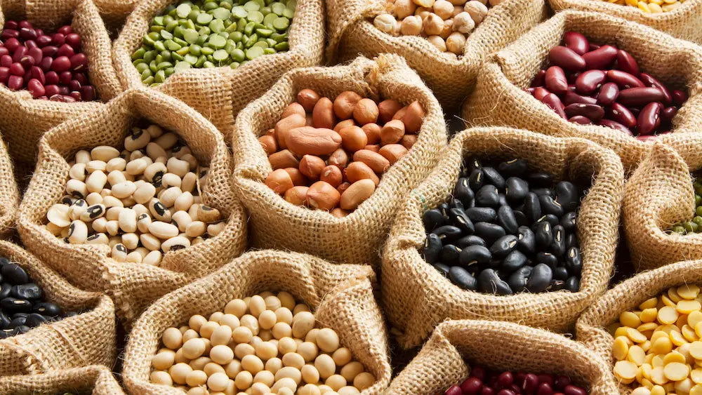 Chickpeas and lentils being served in a colourful home kitchen with natural daylight.