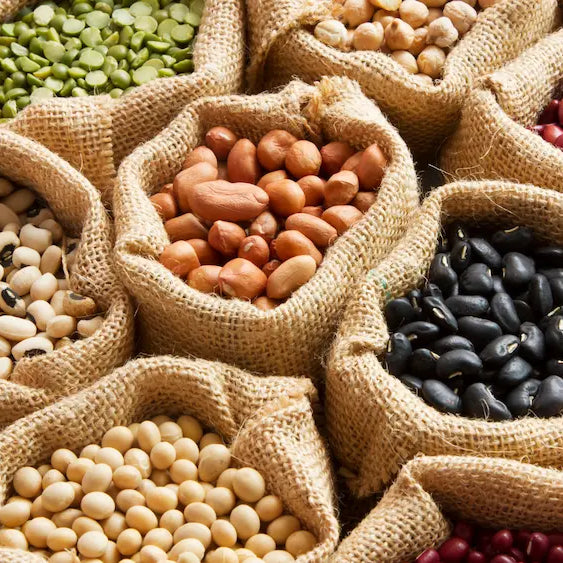Chickpeas and lentils being served in a colourful home kitchen with natural daylight.