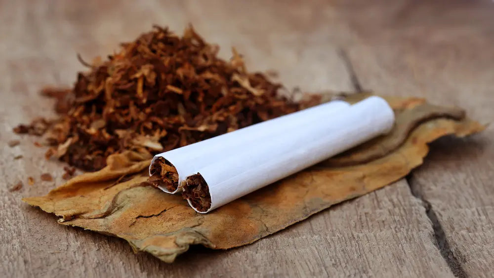 Adult stops using a herbal cigarette after throat irritation and steps away from smoke