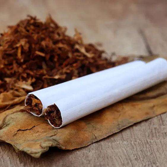 Adult stops using a herbal cigarette after throat irritation and steps away from smoke