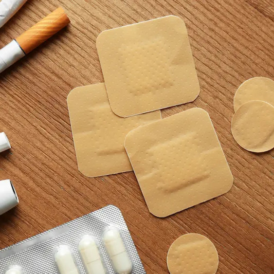 Quit-morning table with nicotine patch, gum, unlit herbal cigarettes and a plan separating withdrawal from smoking routine