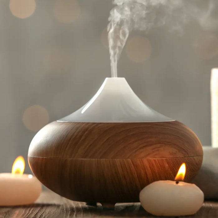 Essential oil diffusers of different tank sizes shown in bedroom, desk and living-room settings with measuring cues