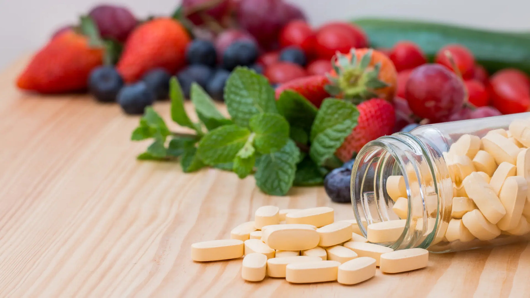 Supplement bottles turned to ingredient panels beside a handwritten vitamin stack audit on a bright New Zealand kitchen bench