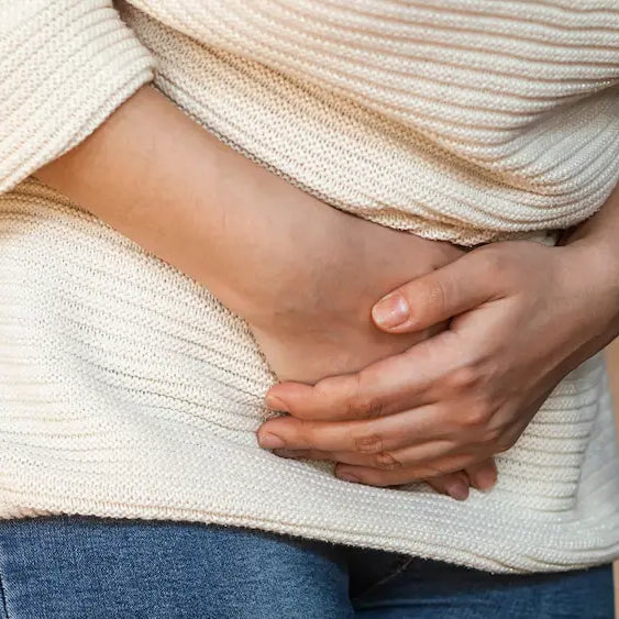 Person comparing probiotic labels while considering a probiotic for bloating in New Zealand