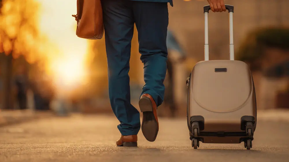 Probiotic bottle being checked beside an open suitcase before travel in a New Zealand home