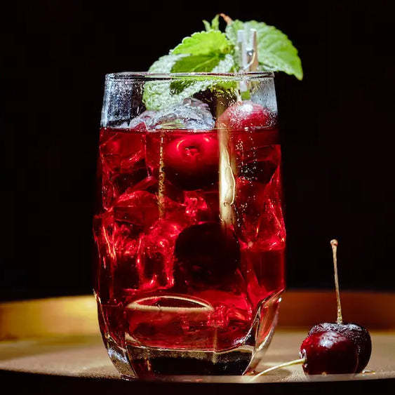 Sleepy Girl Mocktail NZ with deep red cherry drink, sparkling water bubbles and dark cherries