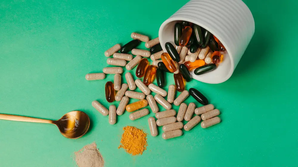 Turmeric supplement and fresh turmeric on a pharmacy counter during a pharmacist consultation in New Zealand.