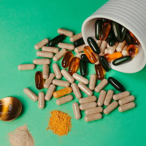 Turmeric supplement and fresh turmeric on a pharmacy counter during a pharmacist consultation in New Zealand.
